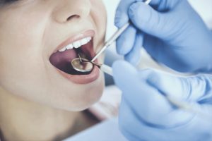 Doctor in Rubber Gloves. Examine Teeth of Patient. Closeup Checking Condition of Mouth. Healthcare Concept. Medicine and Care. Treatment at Dentist Office. Medical Treatment. Dental Hygiene.