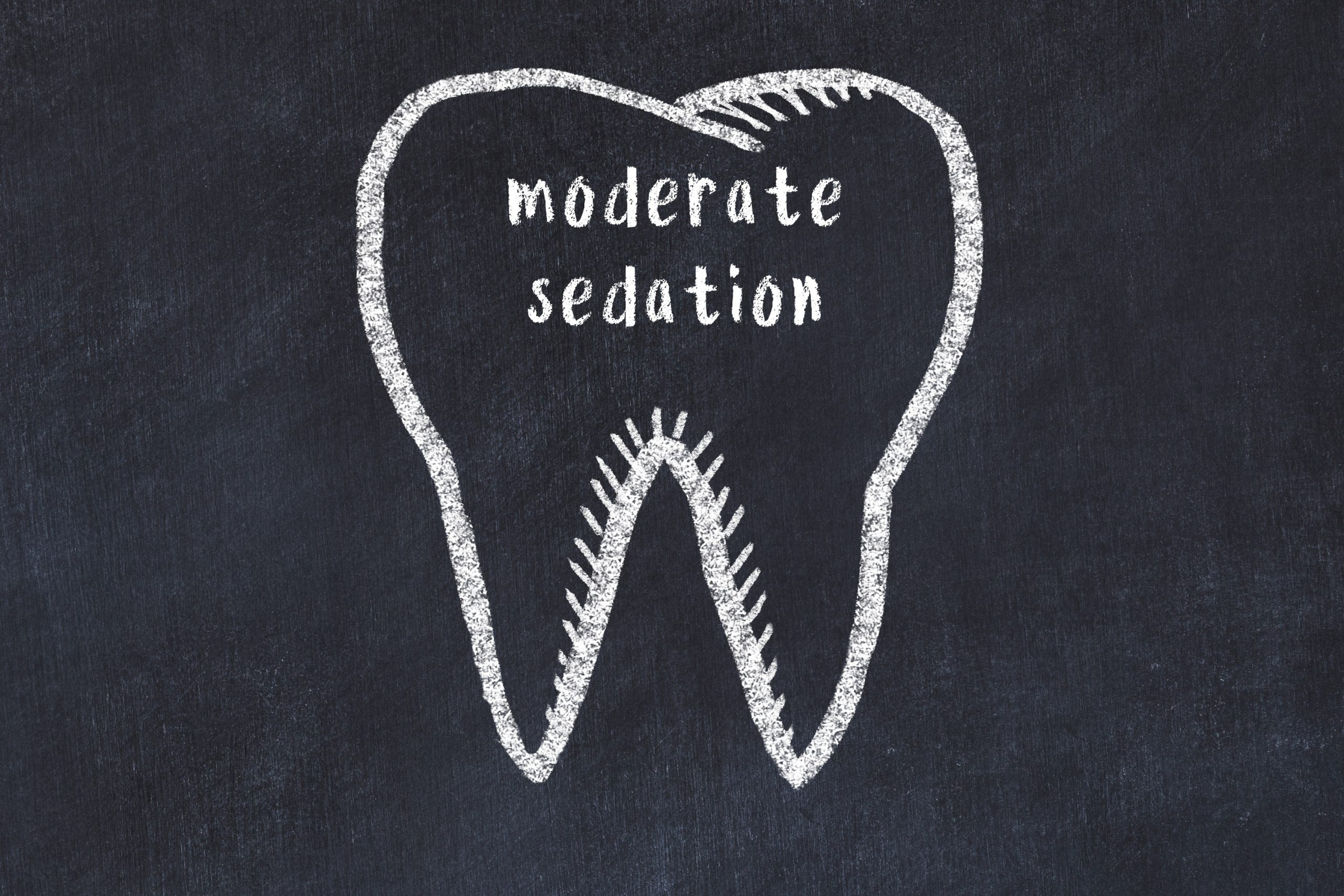 Chalk drawing of a tooth with medical term moderate sedation. Concept of learning stomatology.