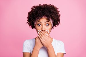 Close up photo beautiful amazing she her dark skin model lady arms hands palms hide mouth lips staring confused eyes full fear wear head scarf casual white t-shirt isolated pink bright background.