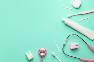 Set for oral hygiene with stethoscope on color background