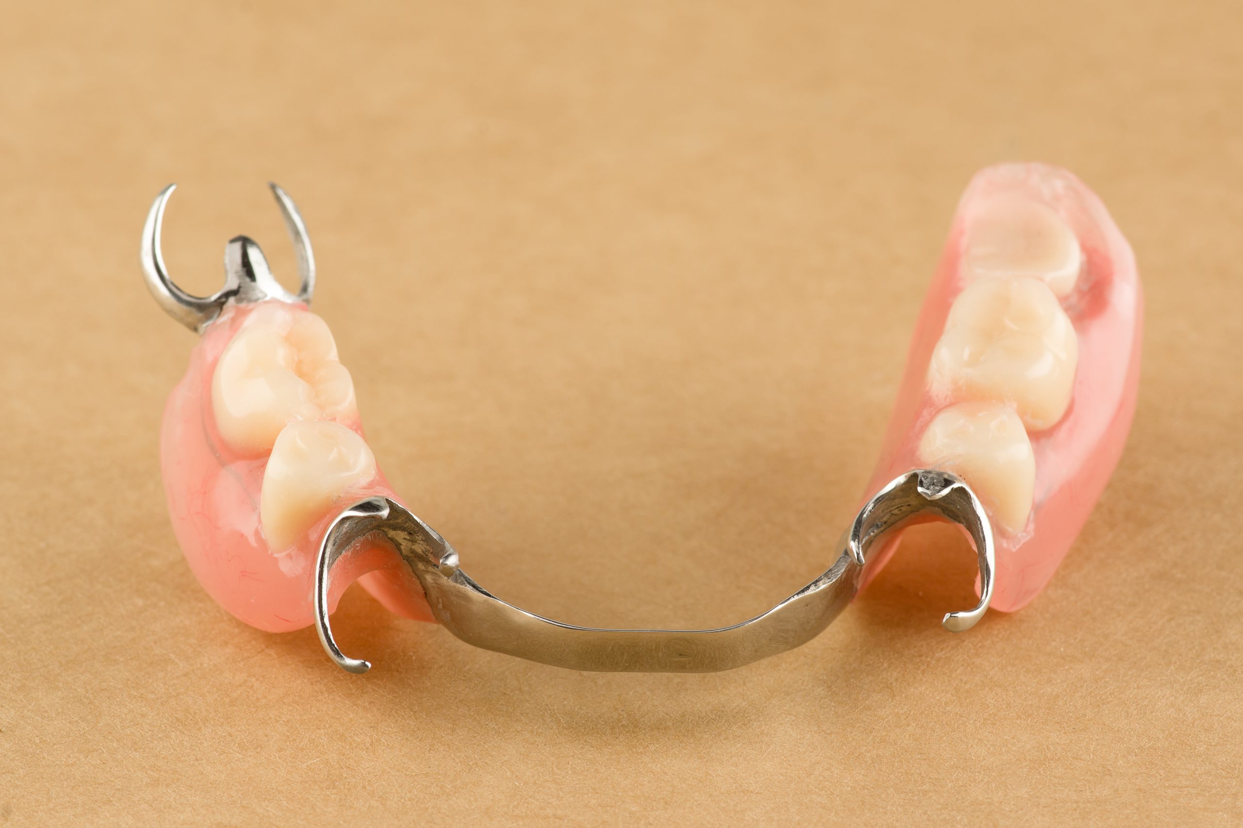 arc dental prosthesis lies on a wooden background