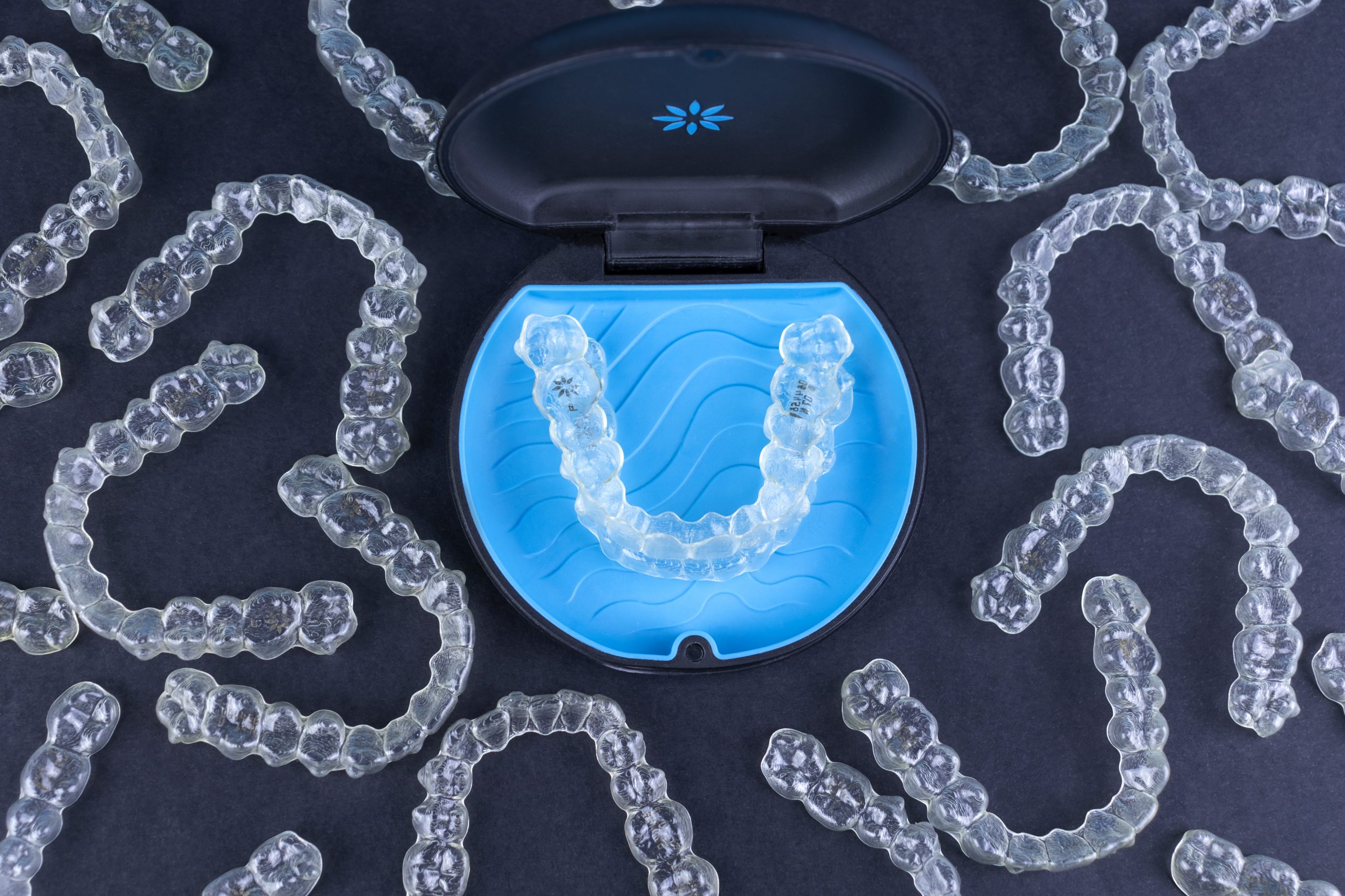 Plastic case with invisible transparent orthodontic retainers invisalign. Aligner brackets or braces dental container