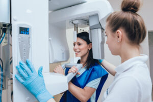 Young woman patient standing in x-ray machine. Panoramic radiography