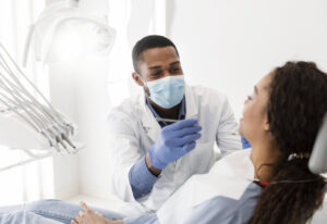 African american male dentist making treatment in modern clinic