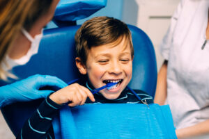 Doctor dentist teaching a child to brush teeth. Dentist concept.