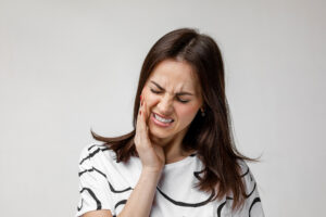 young sad woman suffering from tooth pain, caries. girl having toothache. Dental health and care concept