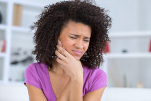 pretty african american young woman have a toothache