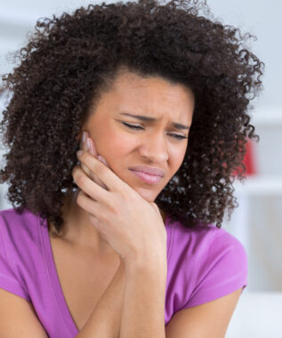 pretty african american young woman have a toothache