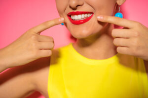 Close up of smiling face. Bright red lips make up.