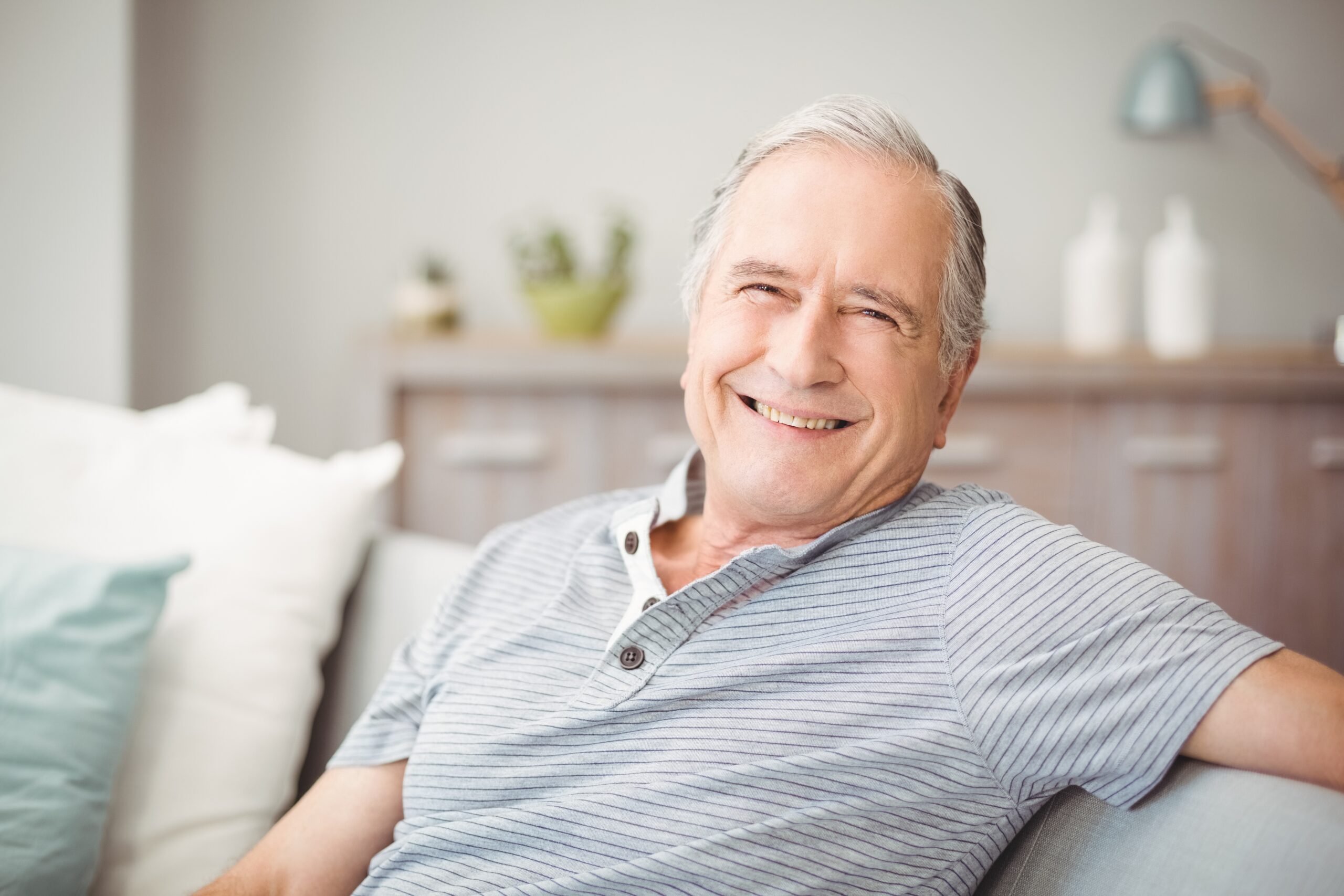 Smiling senior man sitting on couch